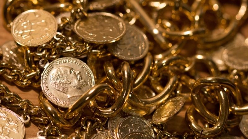 a pile of gold coins a jewels